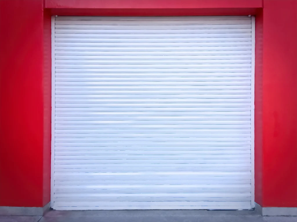 white-roll-up-door-on-red-wall-of-the-garage-2024-05-27-06-52-33-utc-min